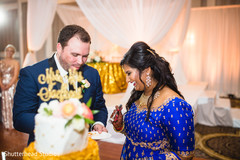 Indian couple tasting their wedding cake Indian couple tasting their wedding cake