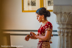 Indian bride putting jewelry on Indian bride putting jewelry on