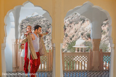 Indian groom being helped to get ready Indian groom being helped to get ready