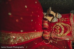 Marvelous Indian bridal red bangles, shoes, lehenga and golden jewelry. Marvelous Indian bridal red bangles, shoes, lehenga and golden jewelry.