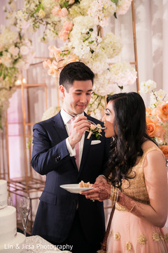 Indian wedding cutting the cake scene Indian wedding cutting the cake scene