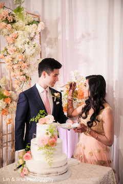 Sweet indian couple cutting their wedding cake Sweet indian couple cutting their wedding cake