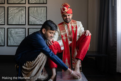 Gorgeous Indian groom getting his shoes on. Gorgeous Indian groom getting his shoes on.