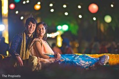 Charming Indian couple taking a portrait under the light decoration. Charming Indian couple taking a portrait under the light decoration.