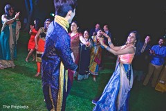 Indian bride enjoys dancing with the groom and the guests. Indian bride enjoys dancing with the groom and the guests.