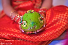 The bride holds the Sriphala. The bride holds the Sriphala.
