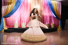 Gorgeous Indian bride in a golden and peach sangeet outfit. Gorgeous Indian bride in a golden and peach sangeet outfit.