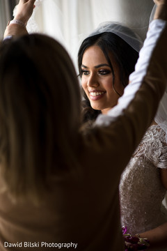 Radiant Indian bride prepares her veil. Radiant Indian bride prepares her veil.