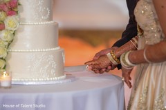 Indian couple cutting their wedding cake Indian couple cutting their wedding cake
