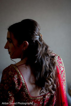 The Indian bride poses with the beautiful red sari. The Indian bride poses with the beautiful red sari.
