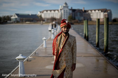 Elegant Indian groom walks in the dock for the photo shoot. Elegant Indian groom walks in the dock for the photo shoot.