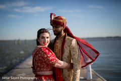 Indian groom stares at his beautiful wife as the photo shoot continues. Indian groom stares at his beautiful wife as the photo shoot continues.