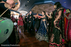 Gorgeous Indian bride wearing the blue sari dancing to the dhol. Gorgeous Indian bride wearing the blue sari dancing to the dhol.