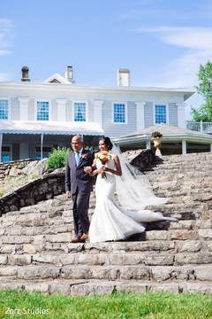 Glamorous Indian bride and parent walking in to wedding ceremony. Glamorous Indian bride and parent walking in to wedding ceremony.