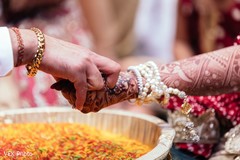 Indian couple's hands meet during one of the rituals.