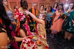 Kid assists the stunning maharani before the ceremony.