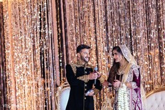 Groom hands the microphone to the maharani for a speech. Groom hands the microphone to the maharani for a speech.