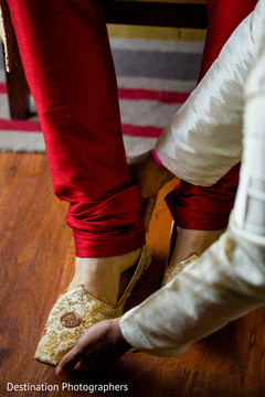 Indian groom being helped to get ready Indian groom being helped to get ready
