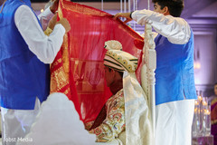 Indian groom being covered with a veil at ceremony waiting for bride. Indian groom being covered with a veil at ceremony waiting for bride.