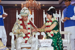 Indian bride putting wedding ring to groom. Indian bride putting wedding ring to groom.