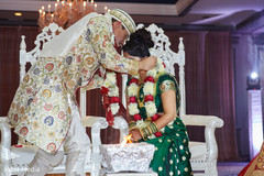 Indian groom putting a necklace to bride during the ceremony ritual. Indian groom putting a necklace to bride during the ceremony ritual.