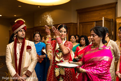 Indian bride throws rice behind her Indian bride throws rice behind her