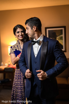 Indian bride helping to groom to get ready Indian bride helping to groom to get ready
