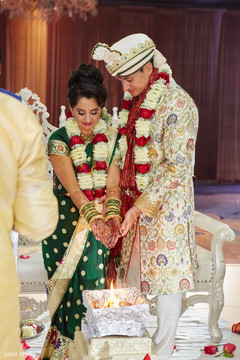 Marvelous Indian couple making offerings to sacred fire. Marvelous Indian couple making offerings to sacred fire.