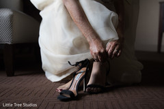 Indian bride changing her wedding shoes Indian bride changing her wedding shoes