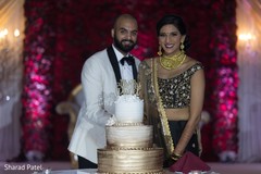 Indian couple about to cut their wedding cake Indian couple about to cut their wedding cake