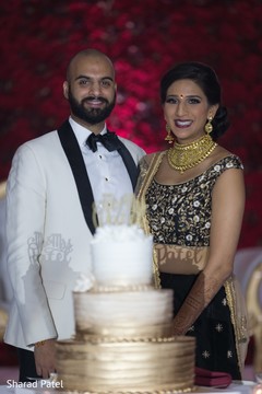Indian couple posing with cake Indian couple posing with cake