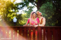 Indian groom whispers at the beautiful maharani during photo shoot Indian groom whispers at the beautiful maharani during photo shoot