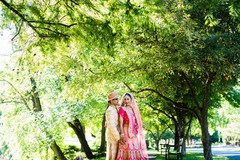 Elegant Indian groom and stunning maharani pose under a tree Elegant Indian groom and stunning maharani pose under a tree
