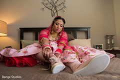 Fabulous indian bride getting her shoes on capture. Fabulous indian bride getting her shoes on capture.