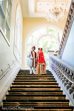 Dreamy portrait of Indian bride and groom standing on the stairs. Dreamy portrait of Indian bride and groom standing on the stairs.