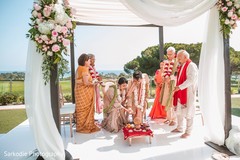 Indian bride and groom throwing the rice to sacred fire. Indian bride and groom throwing the rice to sacred fire.