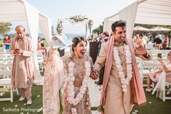 Indian bride and groom walking the wedding ceremony aisle capture. Indian bride and groom walking the wedding ceremony aisle capture.
