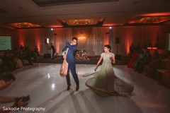 Gorgeous Indian bride and groom at their wedding reception dance performance. Gorgeous Indian bride and groom at their wedding reception dance performance.