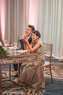 Indian bride and groom capture during reception speech. Indian bride and groom capture during reception speech.