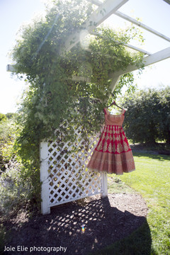 The beautiful sari hangs outside ready to be worn . The beautiful sari hangs outside ready to be worn .