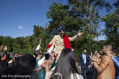 Indian groom is lifted by groomsmen as the Baraat continues Indian groom is lifted by groomsmen as the Baraat continues