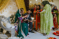 Indian bride and groom at a Sangeet ritual capture. Indian bride and groom at a Sangeet ritual capture.