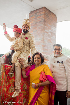 Indian groom posing with parents Indian groom posing with parents