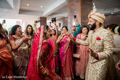 Indian bride and groom dancing during baraat Indian bride and groom dancing during baraat