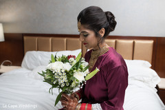 Indian bride admiring her bouquet Indian bride admiring her bouquet