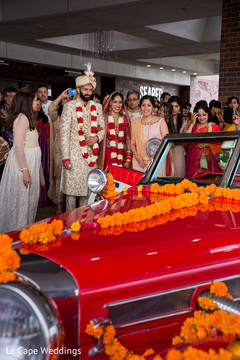 Indian newlyweds stare at the stylish car after the ceremony Indian newlyweds stare at the stylish car after the ceremony
