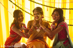 Beautiful shot of the Indian bride and her sisters during the Haldi ceremony Beautiful shot of the Indian bride and her sisters during the Haldi ceremony
