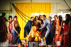 Indian bride is lifted by the special guests during photo shoot Indian bride is lifted by the special guests during photo shoot