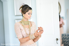 Sweet indian bride putting bangles on. Sweet indian bride putting bangles on.