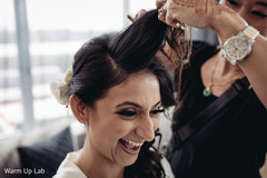Joyful bride getting her hair done. Joyful bride getting her hair done.